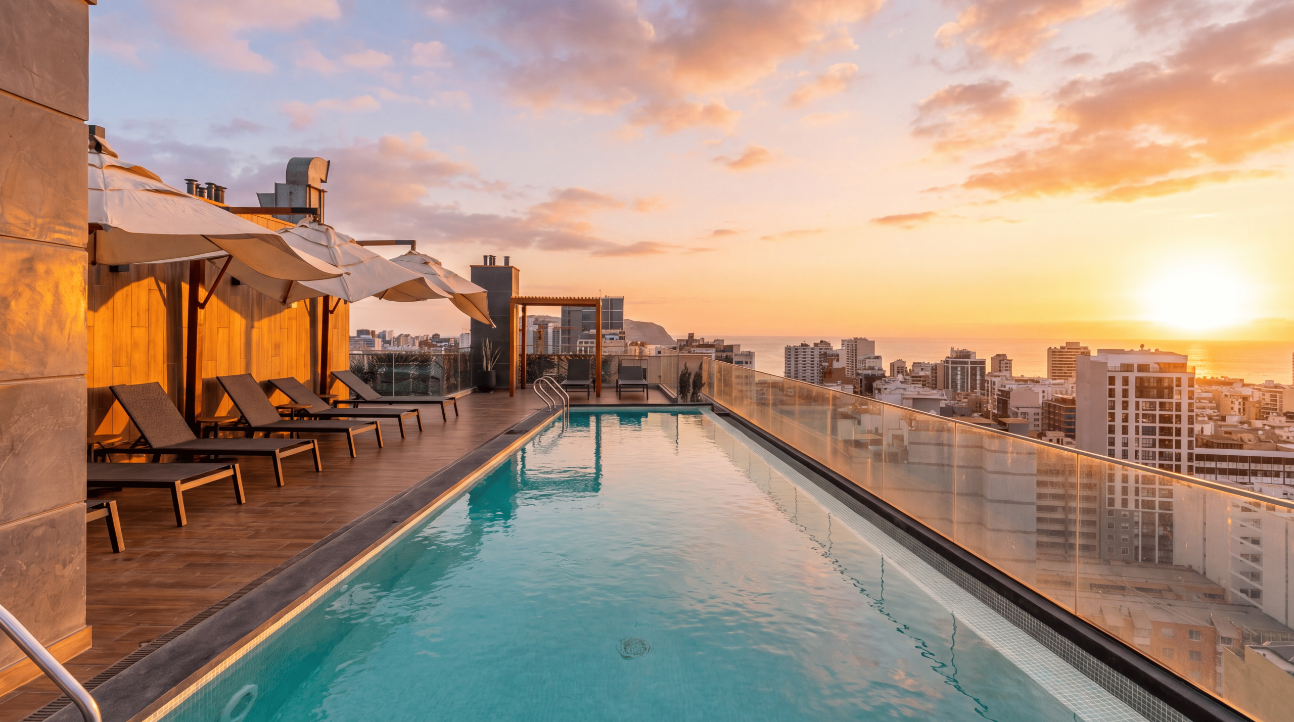 Shared rooftop swimming pool in the AUREN building at sunset